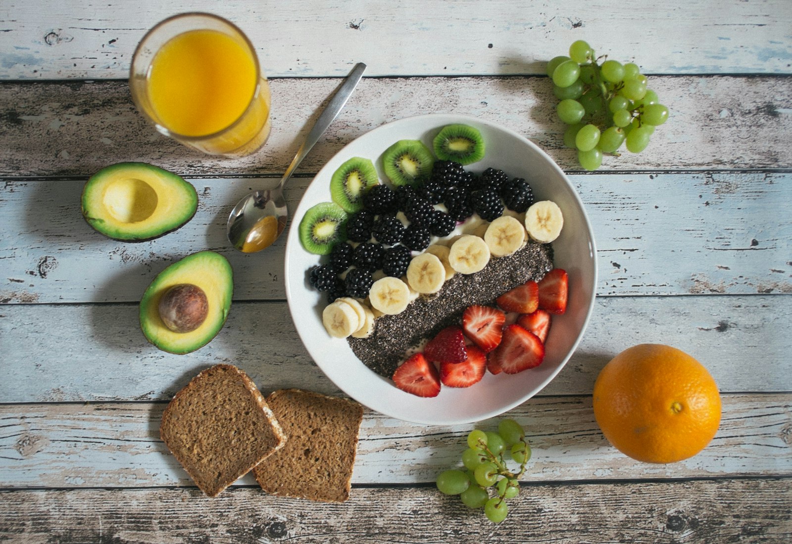 Healthy breakfast with fruit, avocado and juice